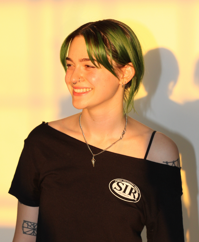 Emmy smiling in front of a white background
