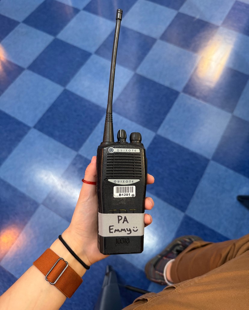 walkie talkie with masking tape that reads "PA Emmy :)"